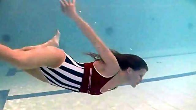 Leggy girl swims and strips naked in pool