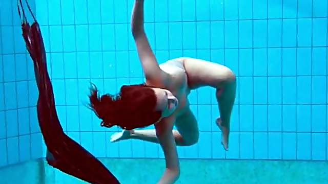 Teen strips from her dress in the swimming pool