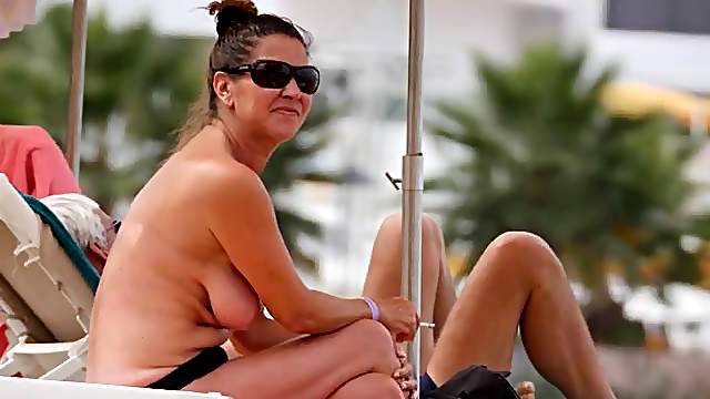 Cute milfs tanning topless on a beach vacation