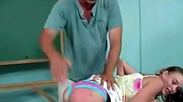 Curly haired teen gets spanked in the classroom